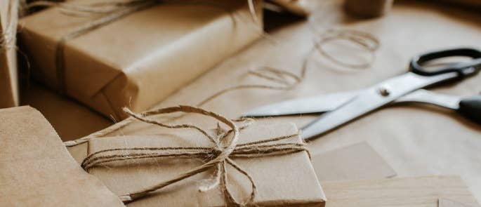 Wrapping presents up in brown paper and tieing with string