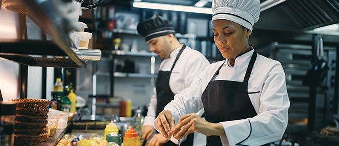Two chefs working together in the kitchen