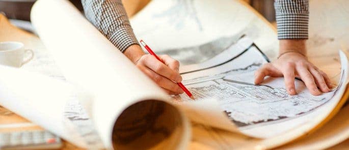 Man Looking at Construction and Design Plans