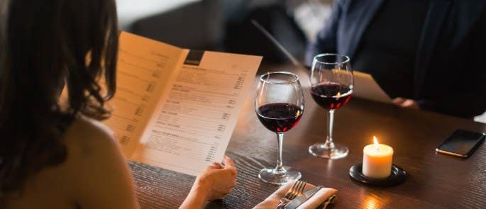 Couple sitting in a restaurant looking at a menu