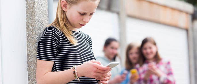 young teen struggling with cyberbullying 