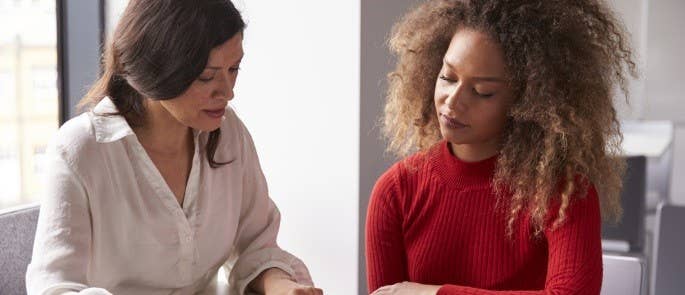 Employer sat with an employee and talking through a sheet