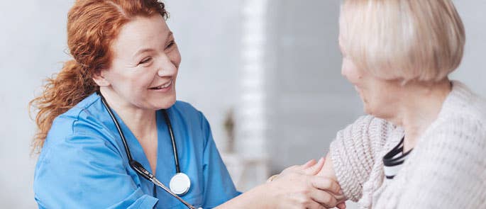a nurse caring for an elderly woman 