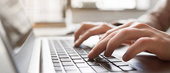 Typing on laptop